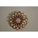 A circular gold floral head blue enamel and pearl brooch/pendant, marked 18k, 4cm diameter (