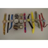 A quantity of modern ladies and gentlemans wristwatches.