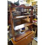 A set of antique mahogany four tier open wall shelves, 64cm wide.