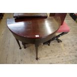 An antique mahogany demi-lune table, with gateleg action, 73cm wide.