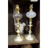 A pair of small brass oil lamps.