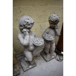 A pair of old weathered composition stone cherubs, 72cm high, ( 1 s.d.)