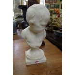 An antique carved white marble bust of a young boy, on socle base, total height 39cm.