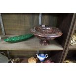 A serpentine pedestal bowl, 26cm diameter, (cracked through socle); and a malachite boat, 28.5cm