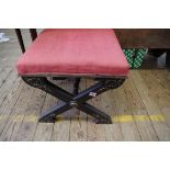 An ebonized and upholstered X frame stool, labelled 'Rose Robinson & Co, Upholsterers and Cabinet