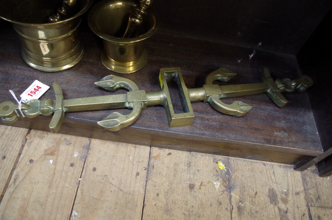 A late 19th century cast brass tiller yoke, in the form of two opposing anchors, 54cm wide.