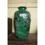 A Continental green glaze pottery vase, relief moulded with figures, 33cm high.