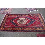 A Persian rug,Â having central floral and geometric medallion, with allover floral and geometric