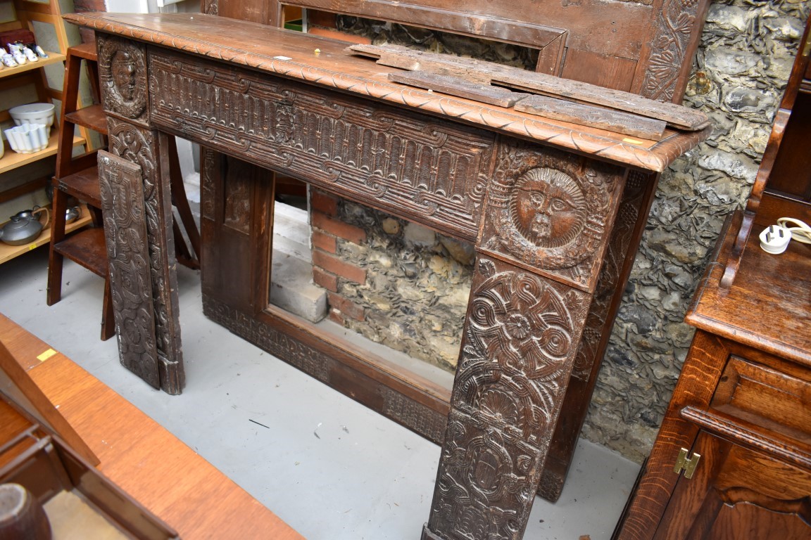 An interesting French carved oak fire surround, containing 16th/17th century elements, the frieze