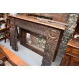 An interesting French carved oak fire surround, containing 16th/17th century elements, the frieze