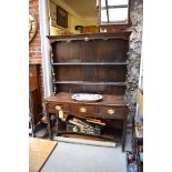 An antique oak dresser and rack, 132cm wide.