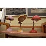 Three vintage painted metal articulated desk lamps.