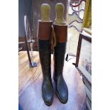 A pair of vintage black leather riding boots,Â approx size 8, with wooden trees.