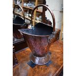 A good Hilton Ware Arts and Crafts copper helmet form swing handled coal scuttle, total height 52cm.