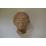 Antiquities: a terracotta female head, probably Roman, 17cm high.