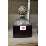 A circa 1900 bronze bust of a boy, 11cm high, on ebonized base.