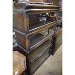 A early 20th century oak four tier sectional bookcase,Â one tier labelled Globe Wernicke, 86.5cm