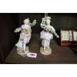 A pair of Meissen porcelain figures, each holding a floral festoon, 17cm high.