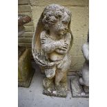 A weathered compositionÂ stone boy,Â 79cm high.