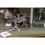 A bronze figure of a stegosaurus, 13cm long.