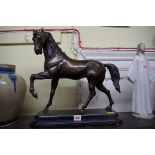 A bronze horse, on marble base, 42cm high.