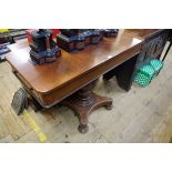 An unusual 19th century mahogany pedestal sofa table, with a pair of opposing lateral frieze