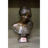 An Art Nouveau bronze bust of a lady,Â indistinctly signed, on bronze socle, total height 21cm.