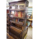 An early 20th century oak five tier bookcase, the lower tier with segmented interior, with apron