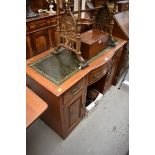 A early 20th century walnut kneehole dressing table,Â with bowfront centre and leather inset top,