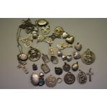 A small quantity of silver and metal pendants and lockets, 129.5g all in.