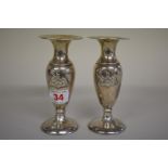 A pair of silver crested baluster vases,Â byÂ R & S Garrard & Co, London 1911, 14cm, weighted.