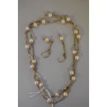 A gold necklace interspersed with pearls, hallmarked 375,Â 73cm 19.9g; together with a matching pair