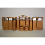 A vintage hanging leather cased set of silver mounted bottles and brushes, different makers and
