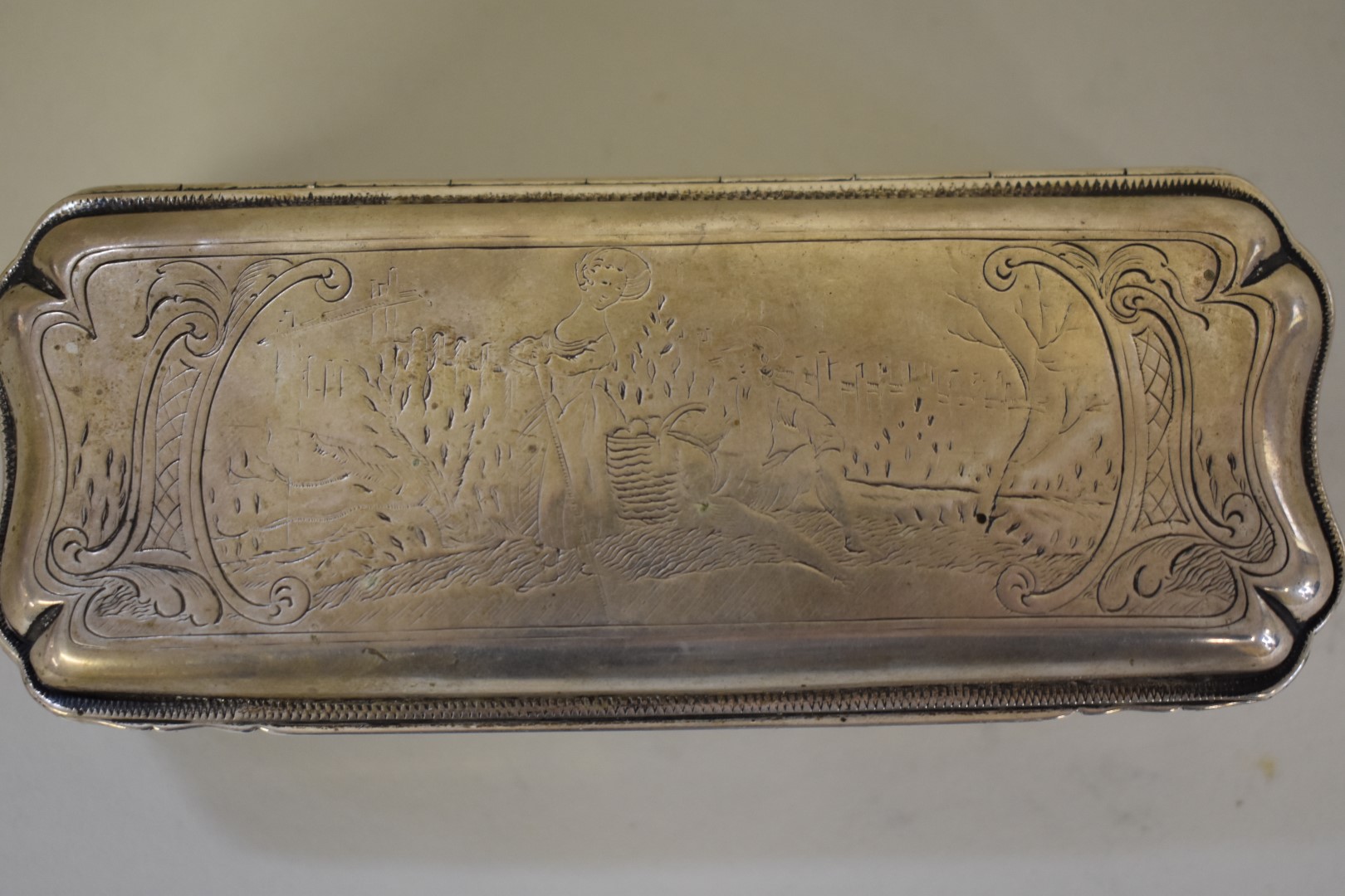 A Dutch white metal tobacco box, having pastoral scenes to both sides, 14cm wide. - Image 4 of 5