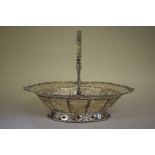 A George lll pierced silver bread basket, by William Plummer, London 1766, having swing handle, 33.