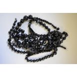 A chunky faceted jet necklace, 80cm long; together with two similar single strand examples, 74cm and