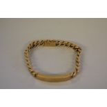 A gold curb link identity bracelet, stamped 375, 35g.