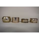 Three various silver napkin rings, 103g; together with one other.