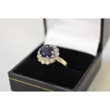 A sapphire and diamond cluster gold ring, stamped 750, 6.5g all in.