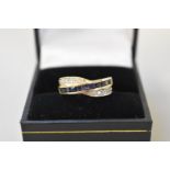 A contemporary sapphire and diamond half hoop gold eternity ring, stamped 14k, 3.9g all in.
