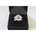 A channel set tanzanite and diamond gold dress ring,Â stamped 14k.