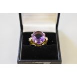 An oval amethyst and diamond gold dress ring, stamped 14k.