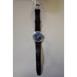 A Bucherer stainless steel gentlemans manual wind wristwatch, having blue dial, on leather strap and