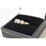 A three stone diamond gold ring, stamped 750, 1ct approximately, 4.3g all in.