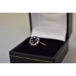 A sapphire and diamond cluster gold ring,Â stamped 18k - 0.8.