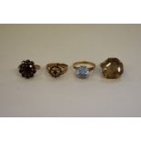 Four various gem set gold dress rings, stamped 375.