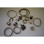 A selection of silver and metal bangles and rings, 88g all in.