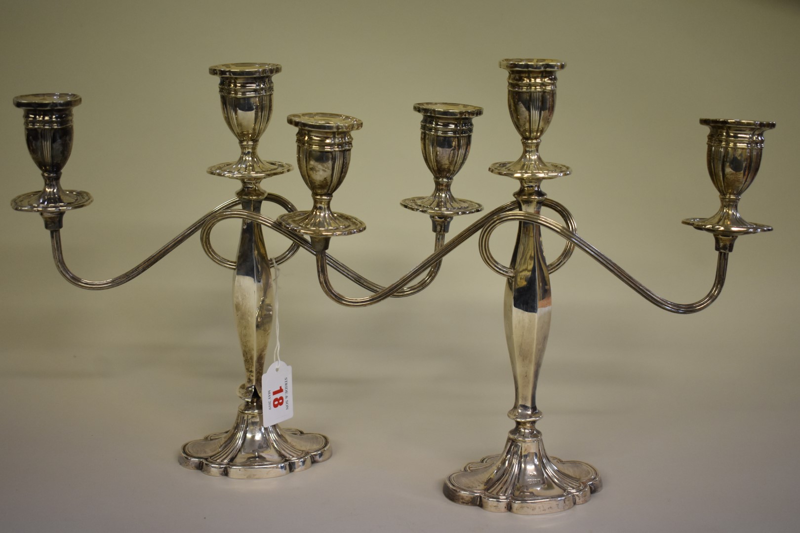 A pair of silver twin branch candelabra,Â by Alexander Smith,Â Birmingham 1976, 27.5cm high.