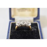 A three stone diamond gold ring,Â hallmarked 18ct, 4ct approximately.