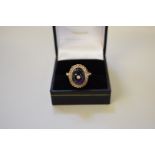 An oval cabochon amethyst ring, set central diamond, stamped 375, 5.1g all in.